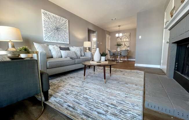 an open living room with a fireplace and a rug
