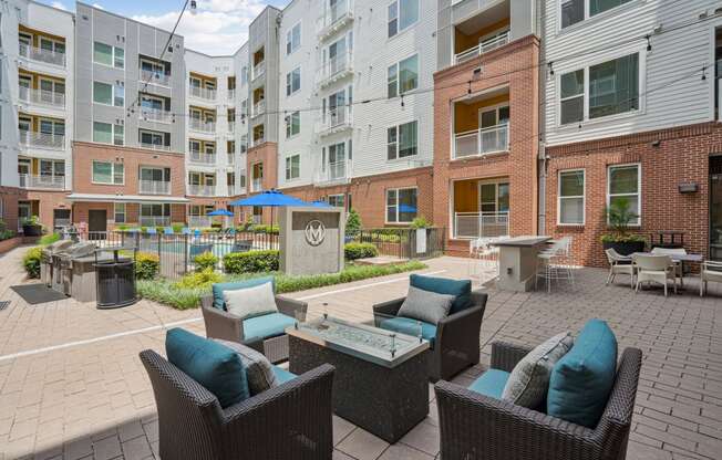 an outdoor patio with furniture and an apartment building