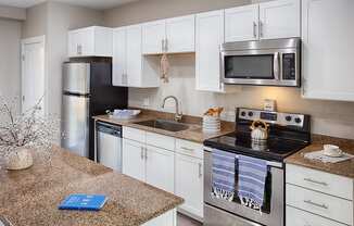 a kitchen with stainless steel appliances and granite counter tops
