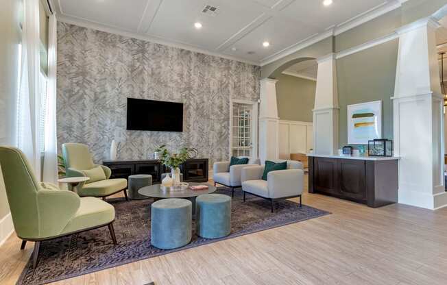 a living room with couches and chairs and a fireplace at Madison on the Meadow, Stafford