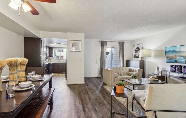 A living room with a dining table and chairs.