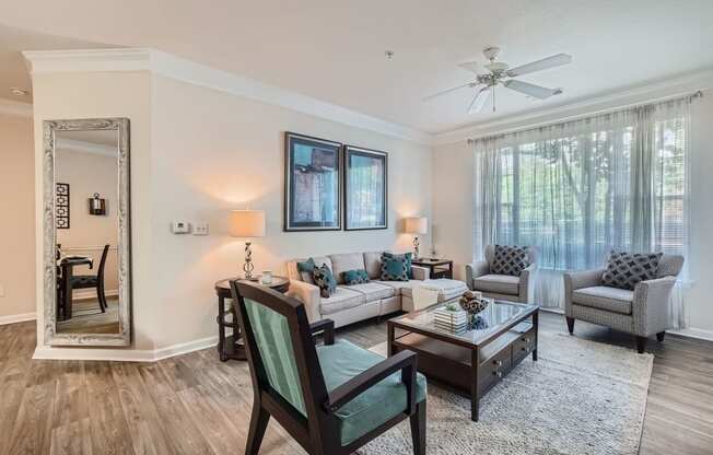 a living room with furniture and a ceiling fan