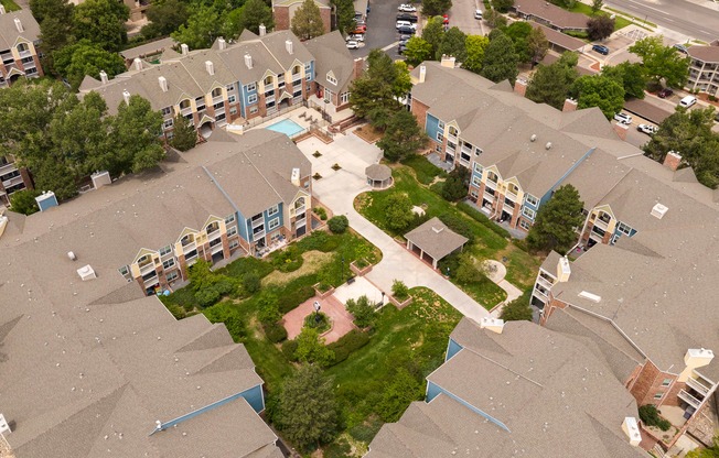 an aerial view of houses in a neighborhood with trees