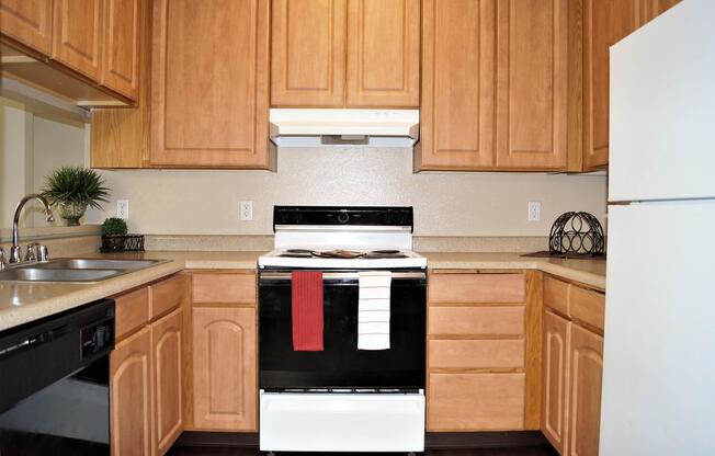 a kitchen with wooden cabinets and a black stove top oven