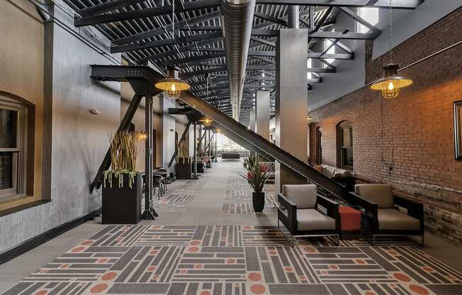 a lobby with a large staircase and a rug on the floor at The Knights @ 506 Delaware Apartments, New York