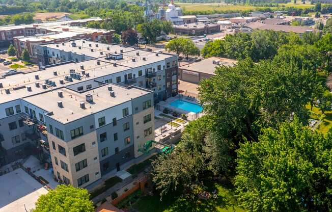 an aerial view of a building with a pool in the middle of it