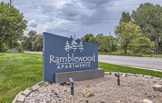 a sign apartments on the side of a road