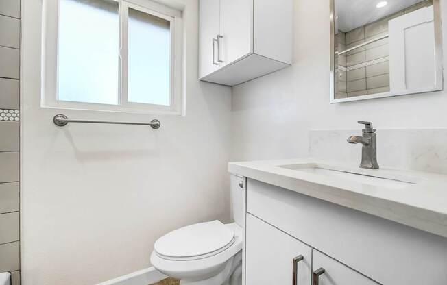 an empty bathroom with a toilet and a sink