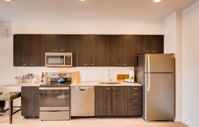 A modern kitchen with a stainless steel refrigerator, oven, and microwave.at Holm at Sellwood, Oregon, 97202
