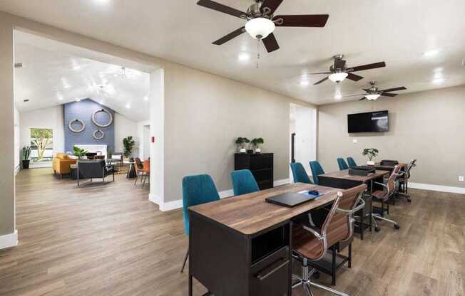 a conference room with a table and chairs and a tv