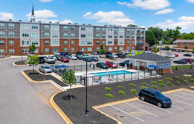 Park View Greer's parking lot in the middle of the complex, with a pool in the middle.