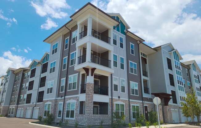 a large apartment building with a blue sky in the background