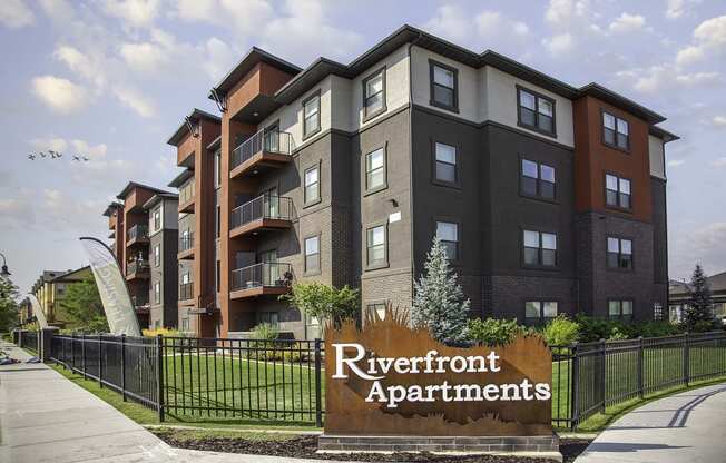 an apartment building with a sign that reads riverfront apartments