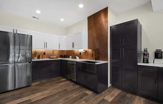 a kitchen with white cabinets and black appliances