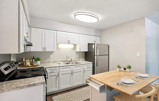 A kitchen with a table set for two.