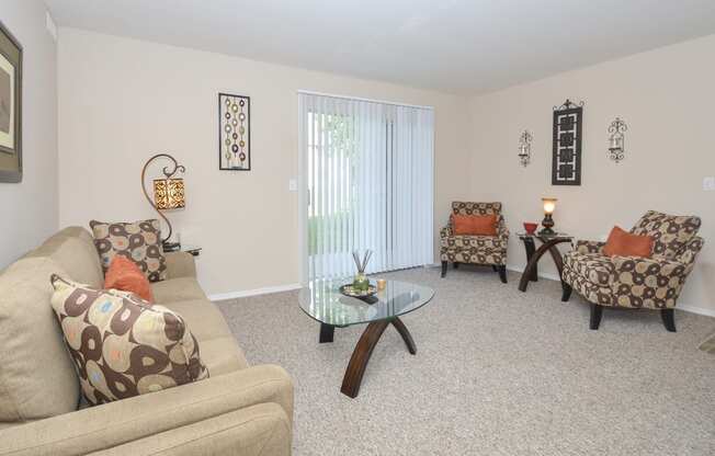 a living room with couches and chairs and a glass coffee table