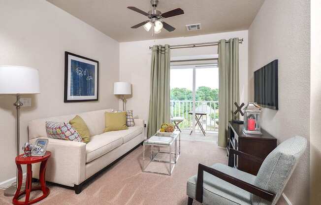 a living room with a couch and a ceiling fan