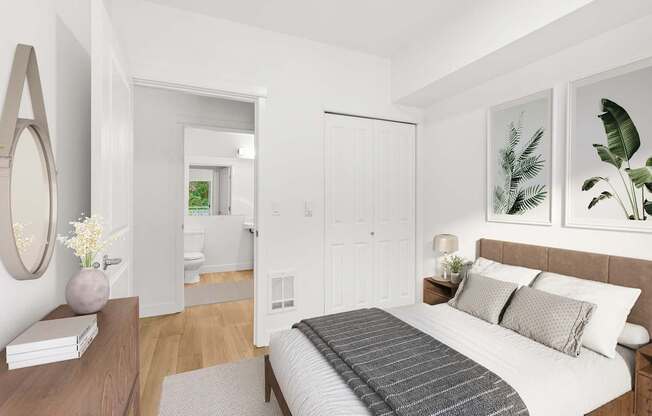 A bedroom with a large bed and a mirror on the wall.