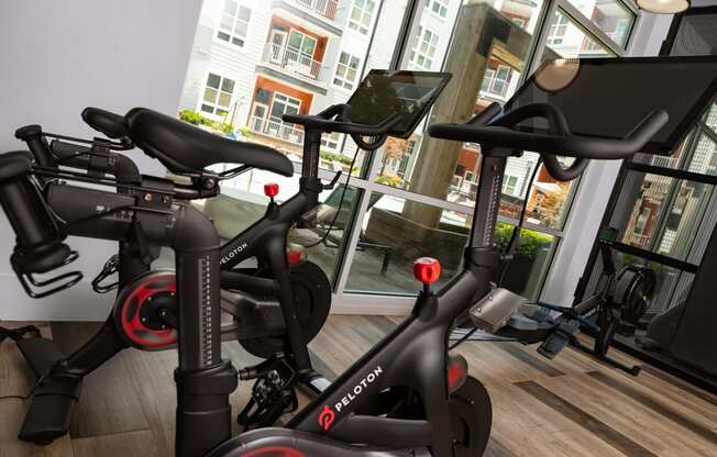 a row of exercise bikes in a gym  at Abberly Noda Vista Apartment Homes, Charlotte, NC