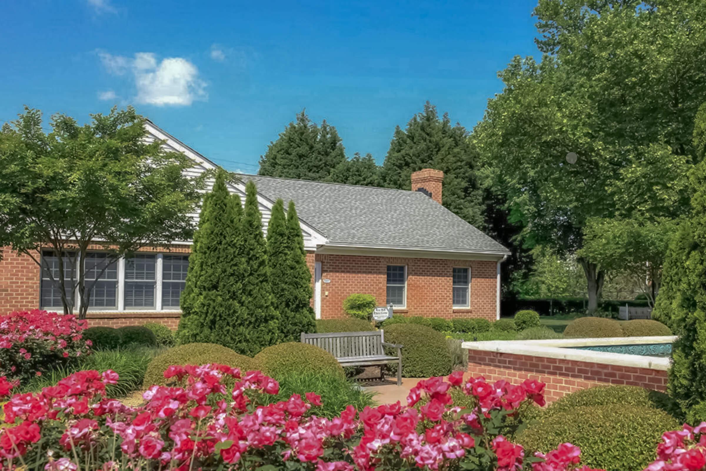 a close up of a flower garden in front of a house