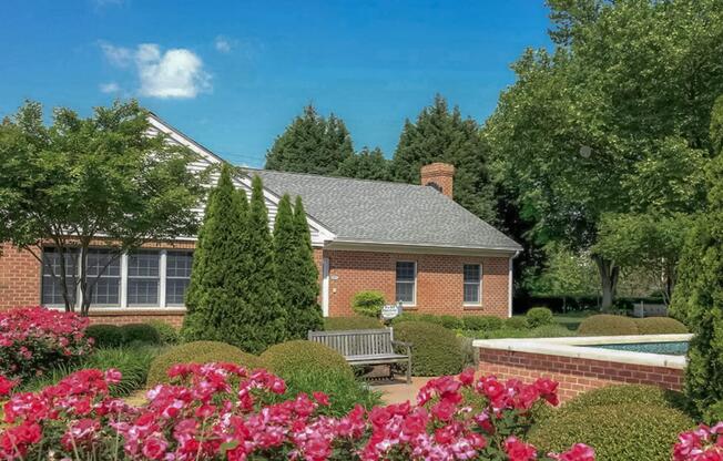 a close up of a flower garden in front of a house