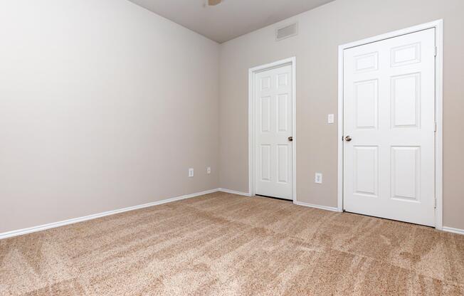 unfurnished bedroom with closed doors