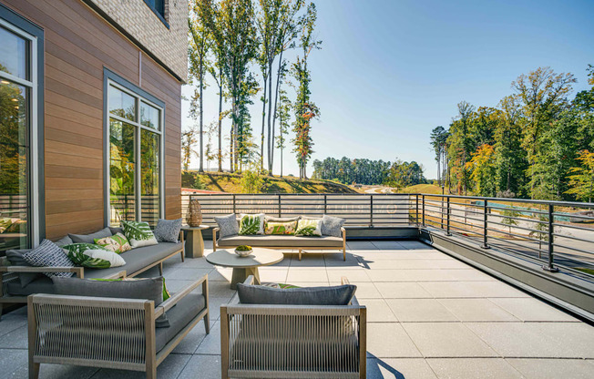 a patio with chairs and tables on a balcony