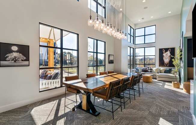 A modern dining room with a large table and chairs.