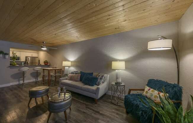 A living room with a white couch and a wooden ceiling.