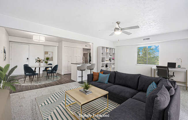 A living room with a grey couch and a coffee table.