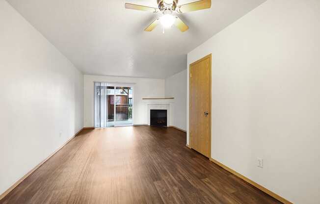 a living room with hardwood floors and fireplace