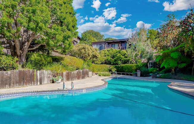 A swimming pool surrounded by a wooden fence and trees at Mariners Village, Marina del Rey, 90292
