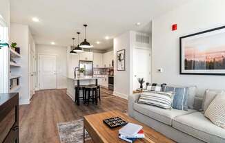 A modern living room with a grey sofa and a coffee table.