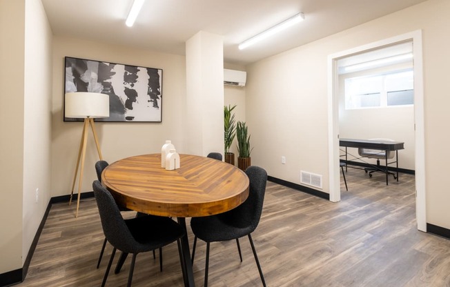 a dining room with a wooden table and chairs