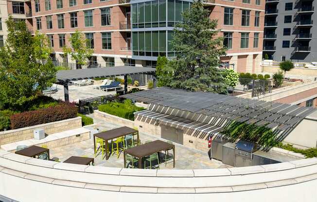 A modern building with a circular courtyard and a glass building in the background.