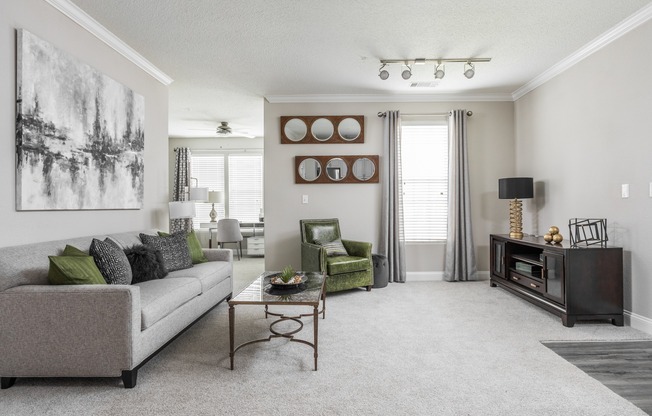 Open apartment floor plan with plush carpeting, a spacious living area, and work from home space