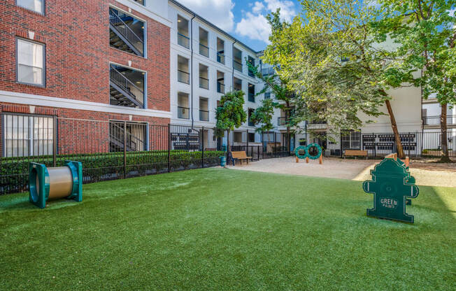 our apartments have a large yard with green grass and a fire hydrant