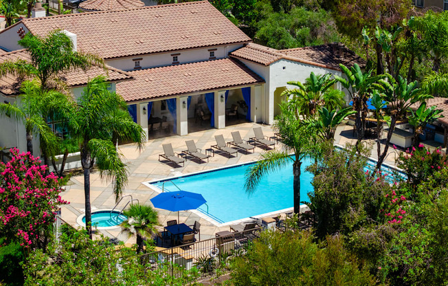 A house with a pool and patio furniture.
