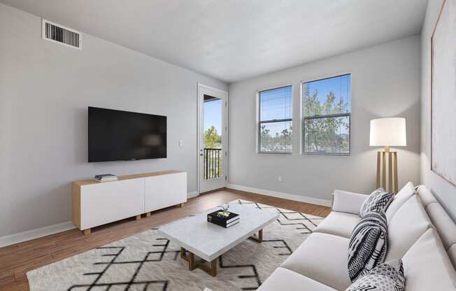 a living room with a white couch and a tv