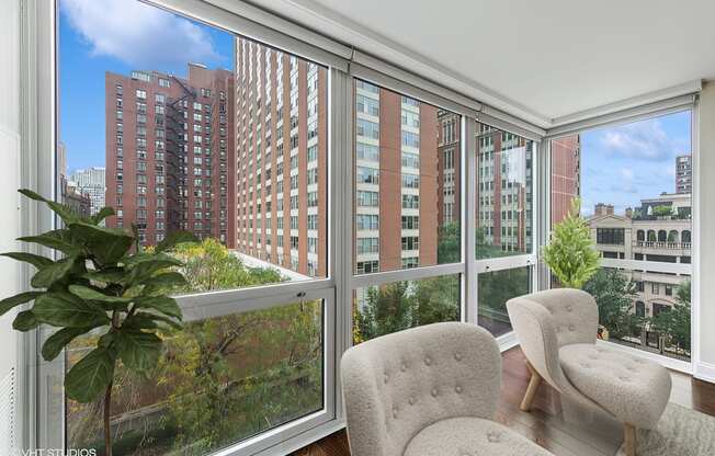 a living room with large windows and a view of the city
