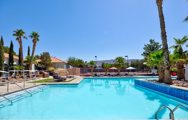 the pool at the club at reunion apartments with palm trees