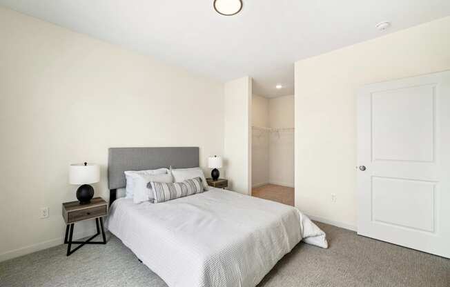 a bedroom with a large bed and a closet at The Standard on 32nd, West Fargo