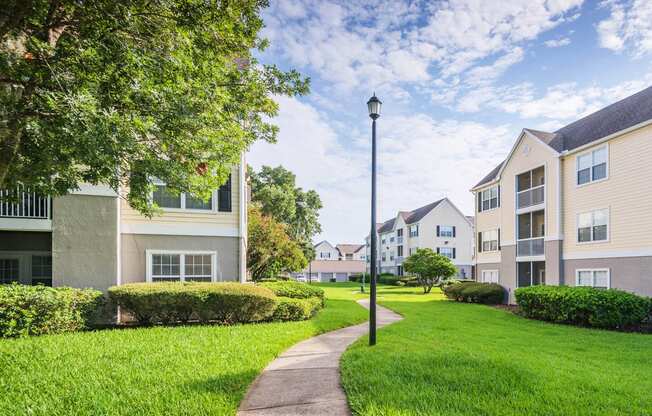 The Colony at Deerwood Apartments - Manicured landscapes with walkways