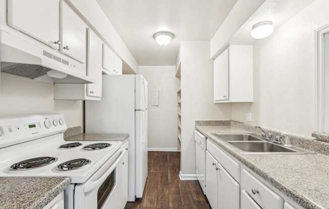 a kitchen with white appliances and counter tops