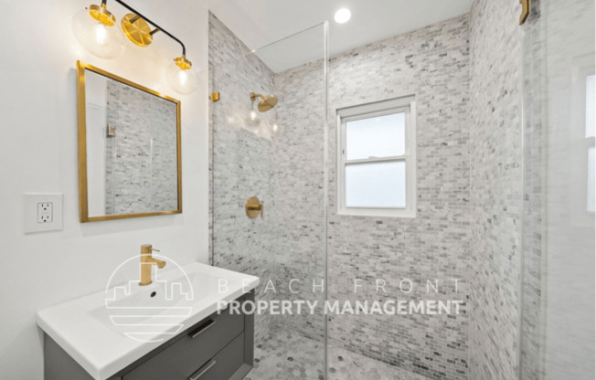 a bathroom with a sink and a shower and a mirror