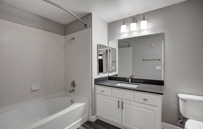 a bathroom with a sink toilet and bathtub