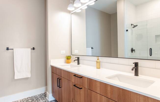 a bathroom with two sinks and a mirror