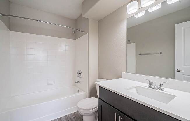A white bathroom with a toilet, sink, and bathtub at Sterling Point Apartment Homes, Phoenix, 85042