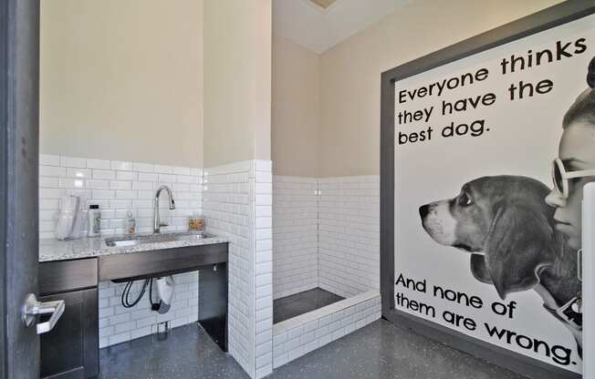 a dog in a bathroom with a sign that says everyone thinks they have the best