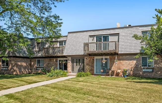 A house with a green lawn in front.